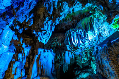 Close-up of icicles on rock in cave