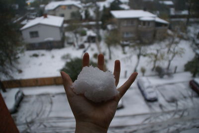 Close-up of woman hand holding snow