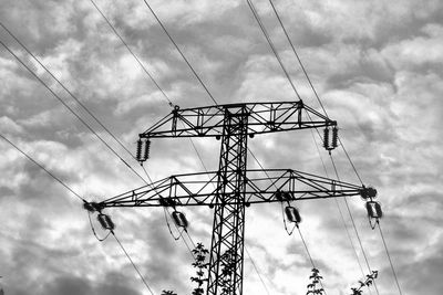 Low angle view of electricity pylon against sky