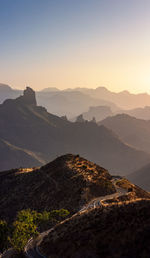 Scenic view of mountains against clear sky during sunset