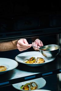 Midsection of person preparing food on table