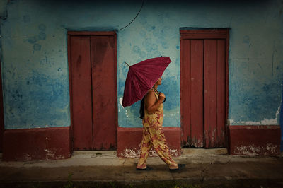 Woman standing by door of building