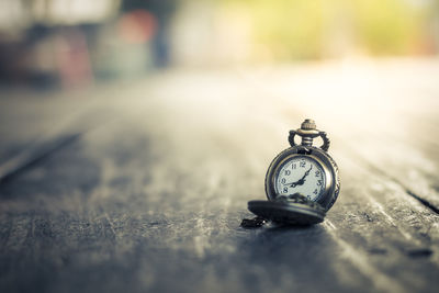 Close-up of pocket watch on table