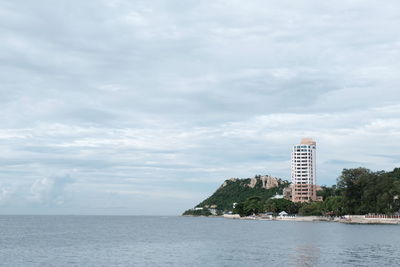 View of sea against buildings in city