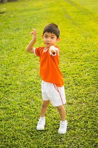 Portrait of boy standing in field