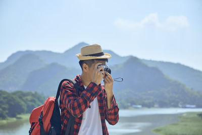 Man standing against mountain range