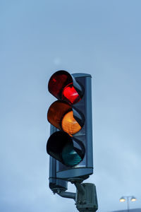 Low angle view of road sign against blue sky