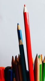 Close-up of colored pencils against white background