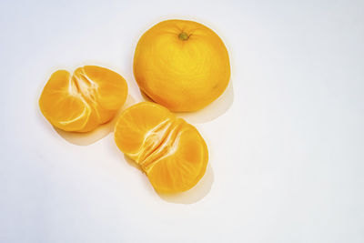 High angle view of yellow lemon against white background