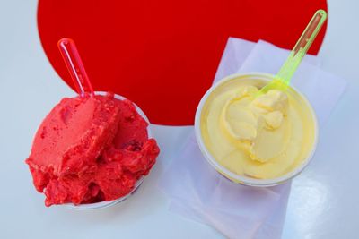 High angle view of ice creams in disposable cups on table