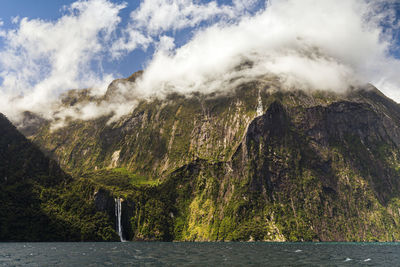 Scenic view of sea and mountains against sky