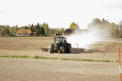 Tractor on a harrow field during spring.