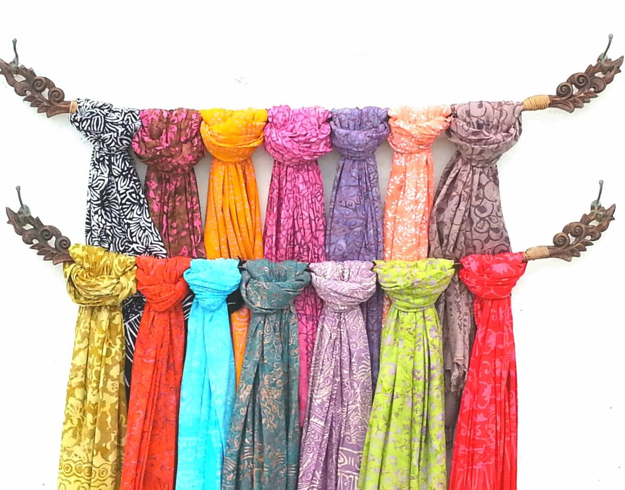 multi colored, art and craft, low angle view, hanging, art, variation, creativity, colorful, human representation, clear sky, decoration, choice, clothing, white background, cultures, temple - building, no people, in a row, textile