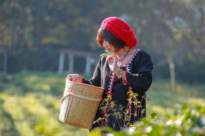 Side view of young woman using mobile phone