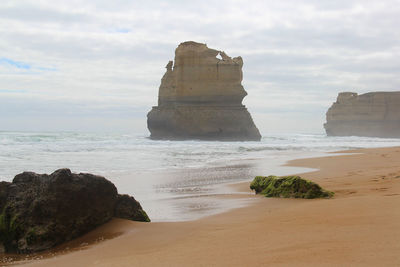 12 apostles rock formation in water by beach 