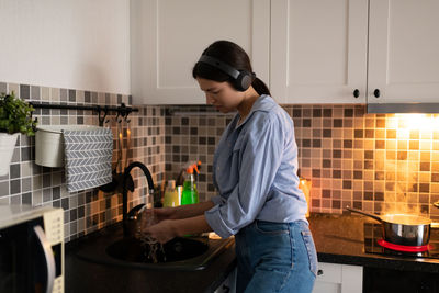 Young woman standing at home