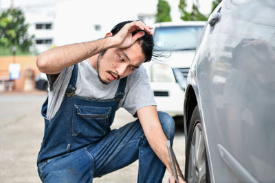 Mechanic tightening car wheel