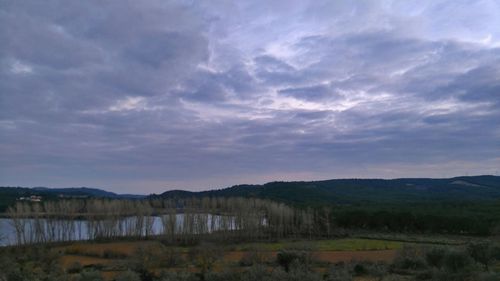 Scenic view of landscape against cloudy sky