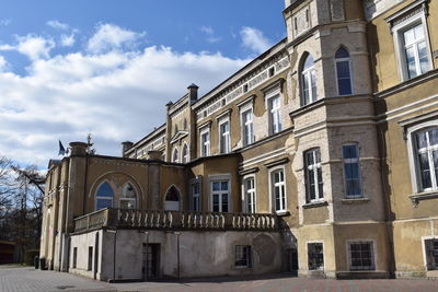 Low angle view of old building against cloudy sky