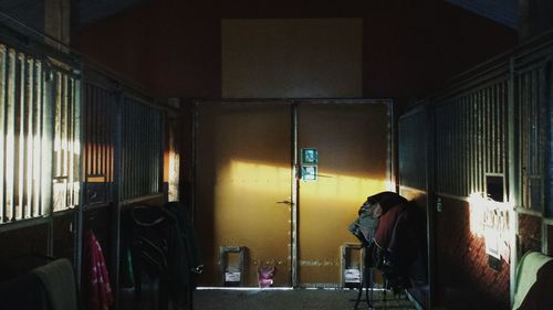 Rear view of man standing on train window at night