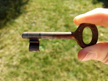 Close-up of person holding stick on field