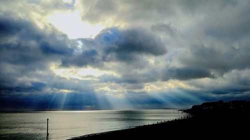 Scenic view of sea against storm clouds