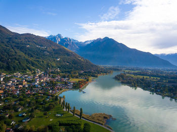 Scenic view of townscape by mountains against sky