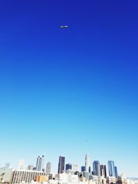 Low angle view of buildings against clear blue sky