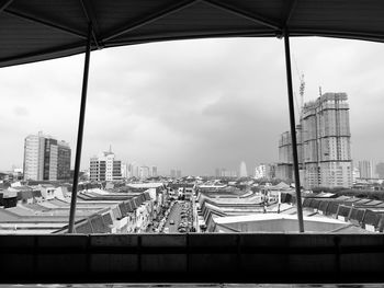 Buildings in city against cloudy sky