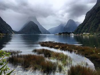 Scenic view of lake and mountains against sky