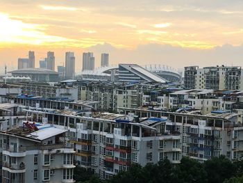 View of cityscape against cloudy sky