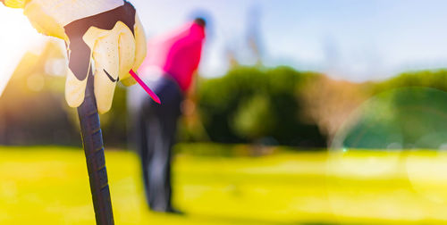 Close-up of yellow flag on field during sunny day