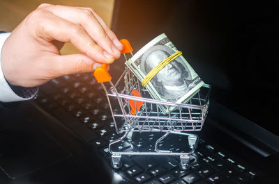 Dollars in the supermarket trolley on the keyboard. online shopping. e-commerce. on the internet. 