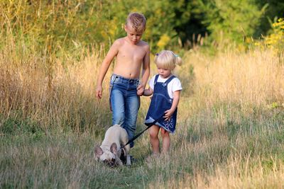 Full length of father and son on grass