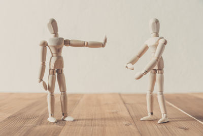 Close-up of wooden figurines on wooden table