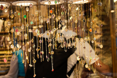 Close-up of decorations hanging in store for sale