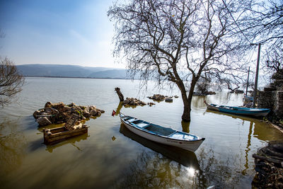 Boats moored in sea against sky