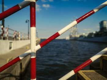 Close-up of metal railing against sky