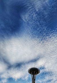 Low angle view of communications tower against blue sky