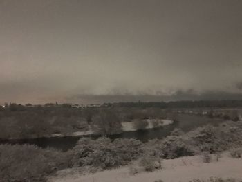 Scenic view of landscape against sky during winter