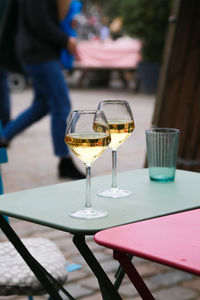 Close-up of wine glasses on table a sidewalk cafe