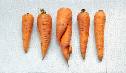 High angle view of orange pepper against white background