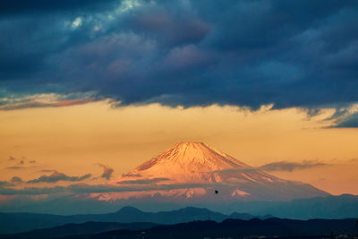 Scenic view of snowcapped mountains against sky during sunrise