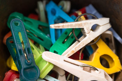 High angle view of multi colored clothespins on metal