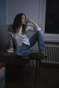 Woman sitting on chair at home