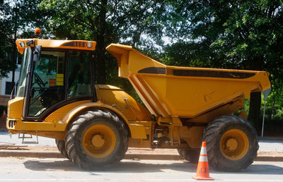 Vintage car on road against trees in city