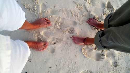 Low section of people standing on beach