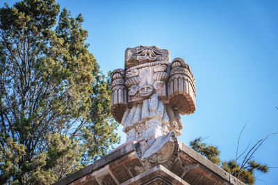 Low angle view of statue against blue sky