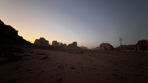 Scenic view of desert against sky during sunset