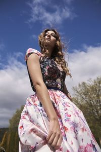 Low angle view of woman against sky